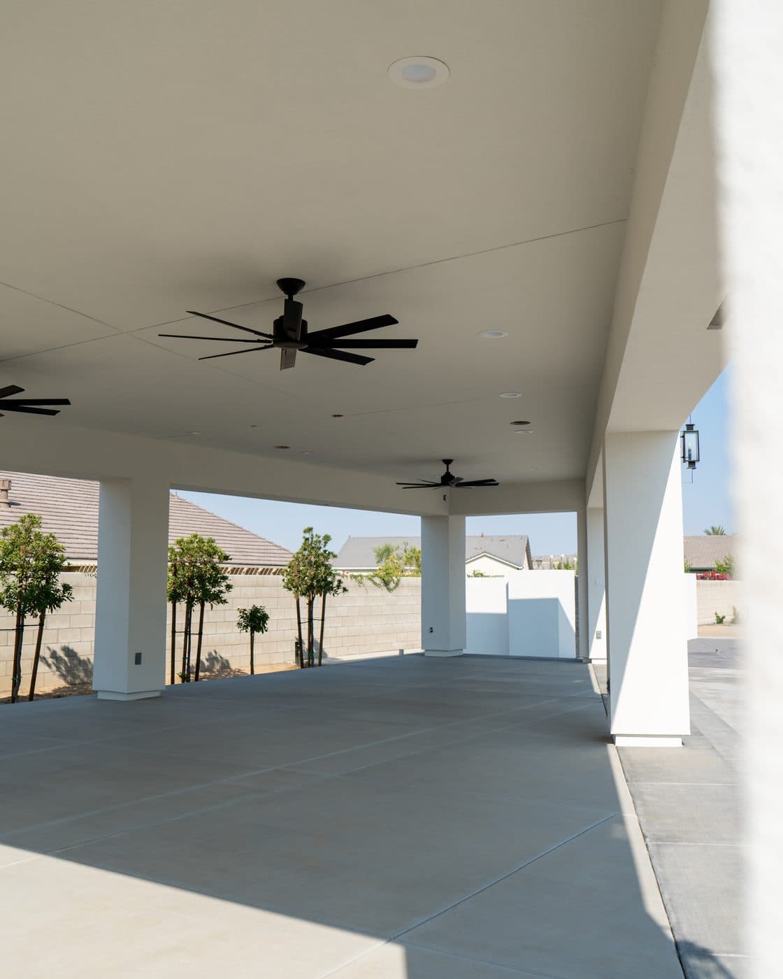 Finished covered patio with smooth-stucco columns by Intrepid Plastering, Bakersfield