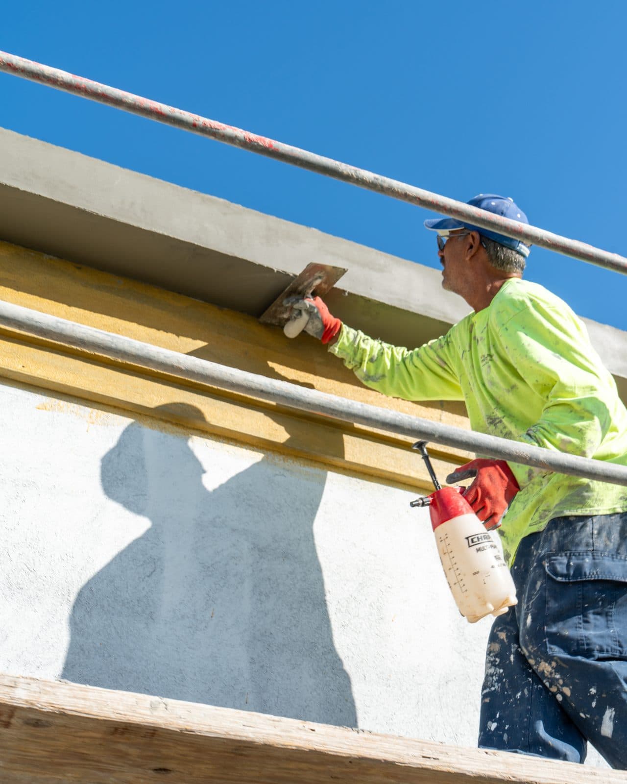 Intrepid Plastering crew troweling exterior stucco in Bakersfield