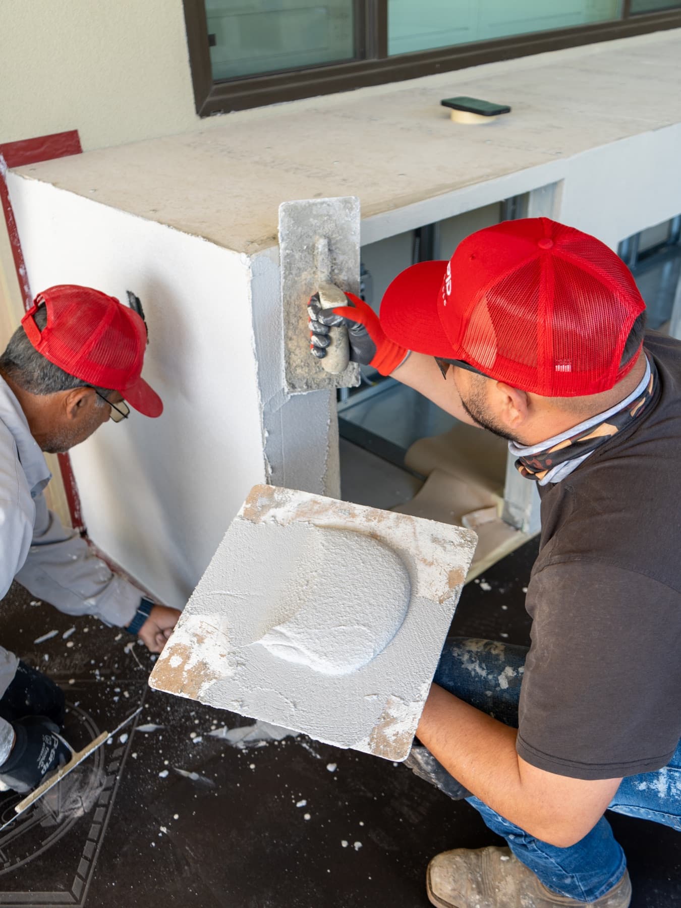 Crew troweling a base scratch-and-brown coat by Intrepid Plastering, Bakersfield
